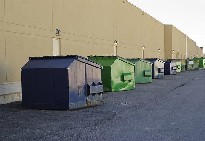 construction workers disposing of debris in large dumpsters in Clarks